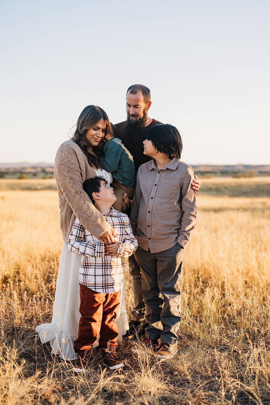 outdoor family photography session featuring parents and children in the grassland of Sonoita AZ
